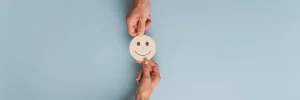 Phot d'un emoji souriant qui passe de main en main